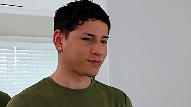 Tattooed lad with a cute face is giving a nice handjob